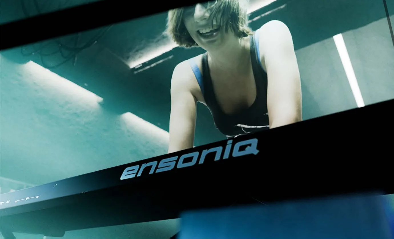 The same shot rendered with ray tracing, Kady playing an Ensoniq keyboard in a teal-lit set.